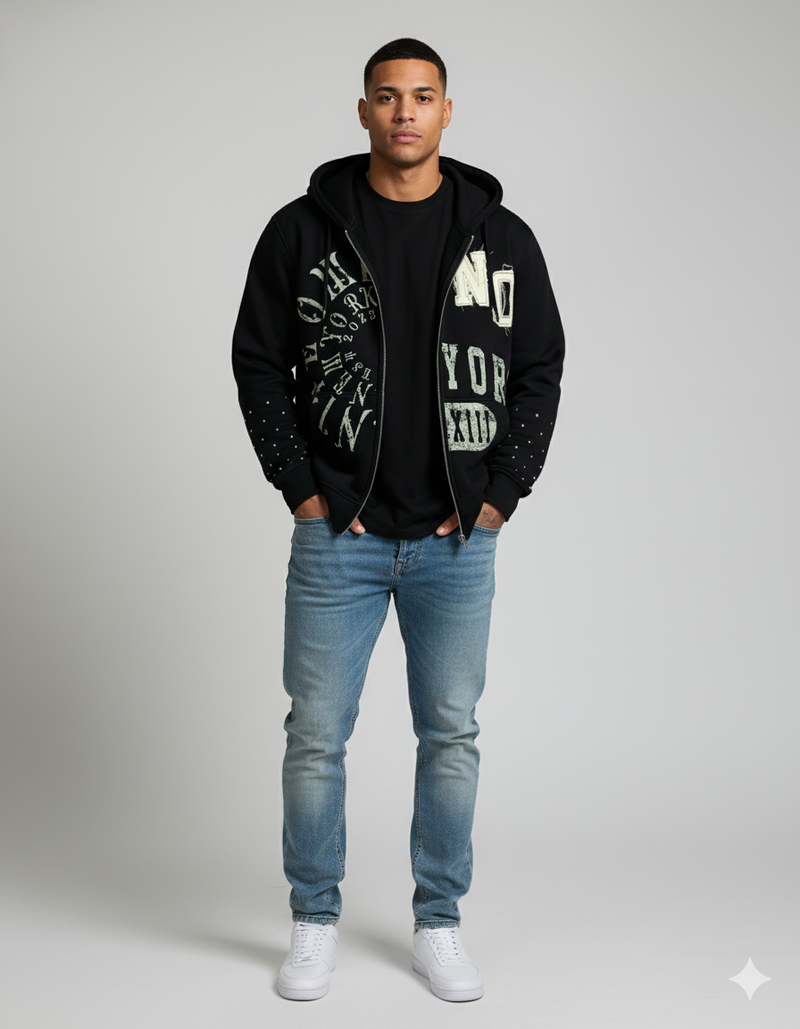 Male model wearing the Nite Owl ‘NO YORK XIII’ rhinestone zip hoodie, showcasing premium black streetwear with bold distressed typography, studded sleeve detailing, and a modern urban fit—ideal for shoppers searching for luxury men’s hoodies, elevated everyday streetwear outfits, and high-quality graphic zip hoodies.