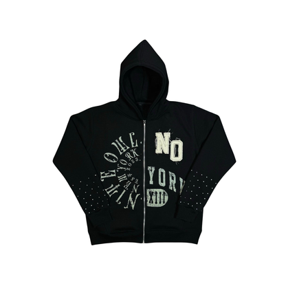 “Flat lay of the Nite Owl ‘NO YORK XIII’ Rhinestone Zip Hoodie in black, featuring premium gold rhinestone graphics across the front and studded sleeves. High-end unisex streetwear hoodie with zip closure, minimalist luxury design, and NYC-inspired typography. Part of the Nite Owl Fall/Winter collection, showcasing premium craftsmanship and bold contemporary fashion.”